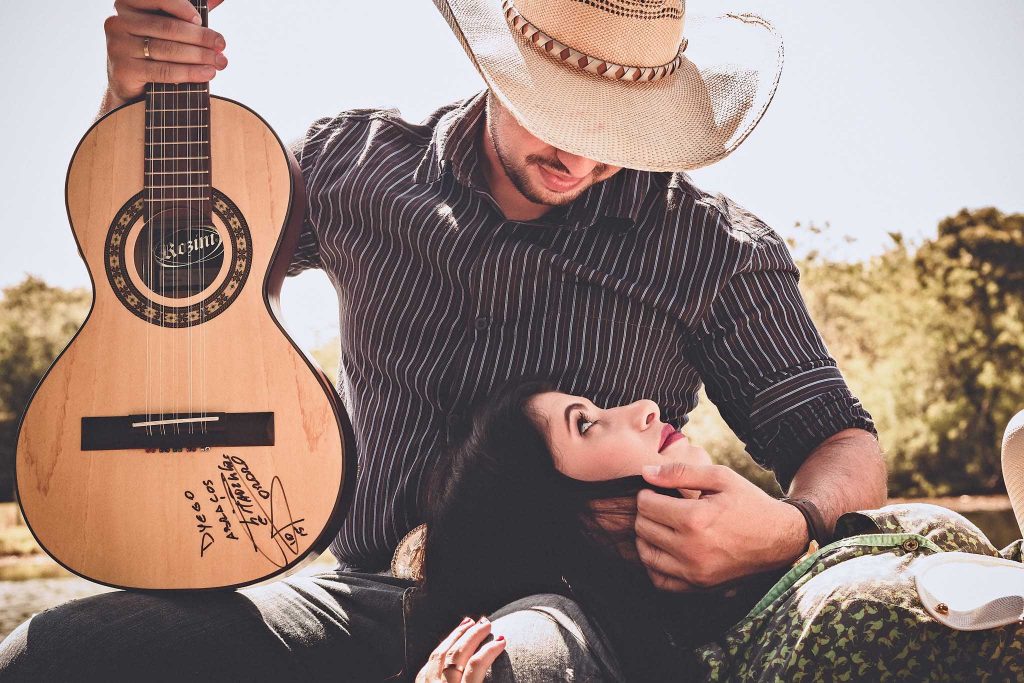 Boy impresses a woman with his guitar talent-photo by pexels..loveyoufamily.com